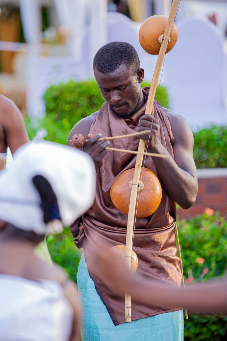 African musician performing with a berimbau, showcasing cultural tradition.