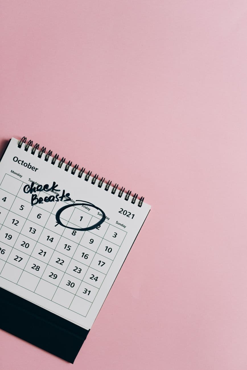 October calendar on pink background for breast cancer awareness with reminder.