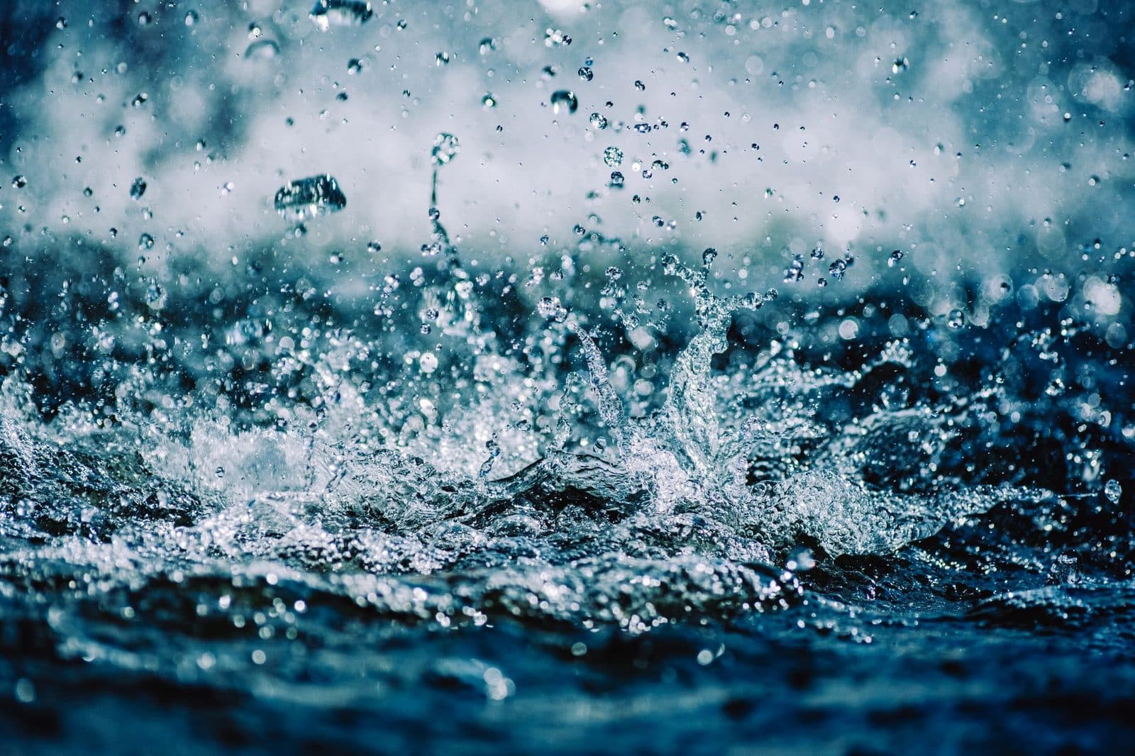 Close-up of dynamic water splash with droplets captured mid-air, showcasing motion and energy.