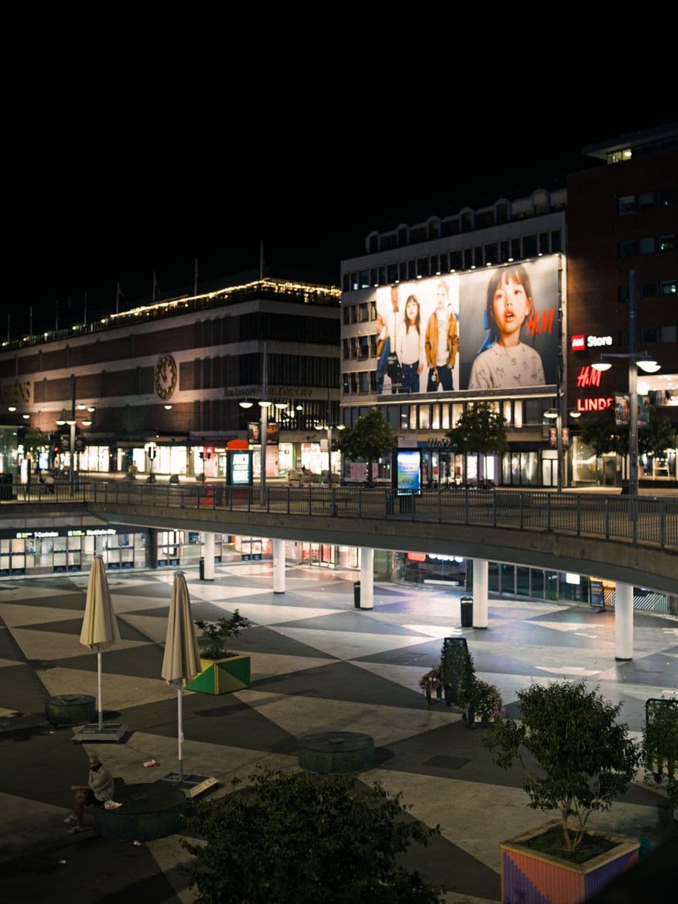 Vibrant night view of Sergels Torg in Stockholm with bustling city lights and modern architecture.
