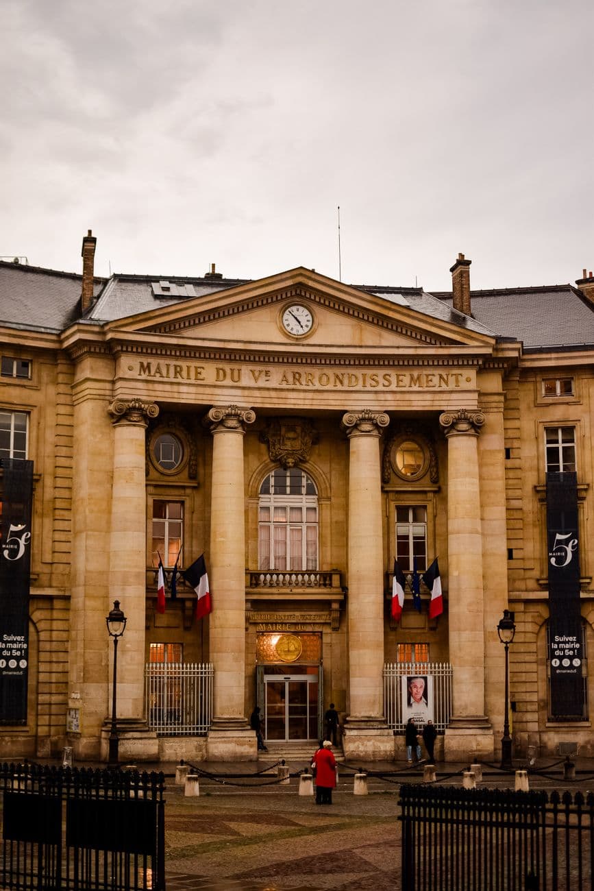 Front view of the historic Mairie du 5e Arrondissement in Paris, showcasing classic French architecture.