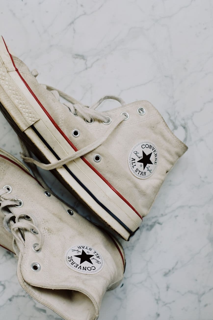 Classic Converse All Star sneakers on a marble surface with a retro vibe.