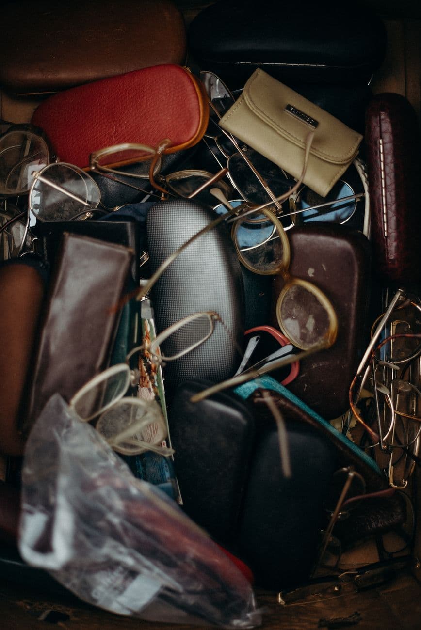 A close-up view of assorted vintage eyeglasses and cases, perfect for retro enthusiasts.