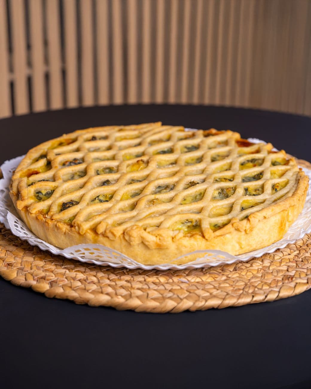 Fresh homemade vegetable quiche with lattice crust, perfect for brunch.