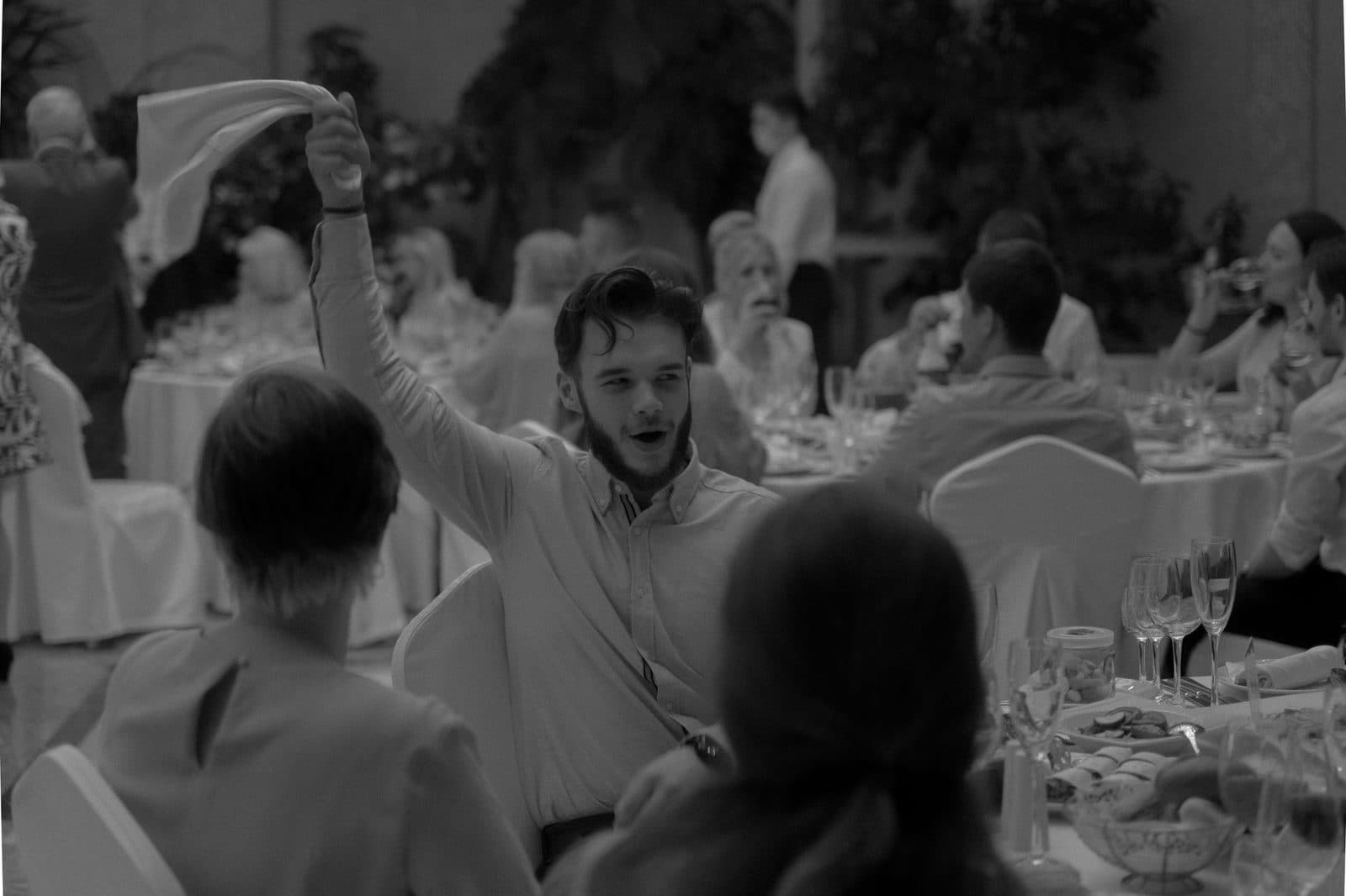 A lively moment captured during a formal dinner event with people celebrating and enjoying the occasion.