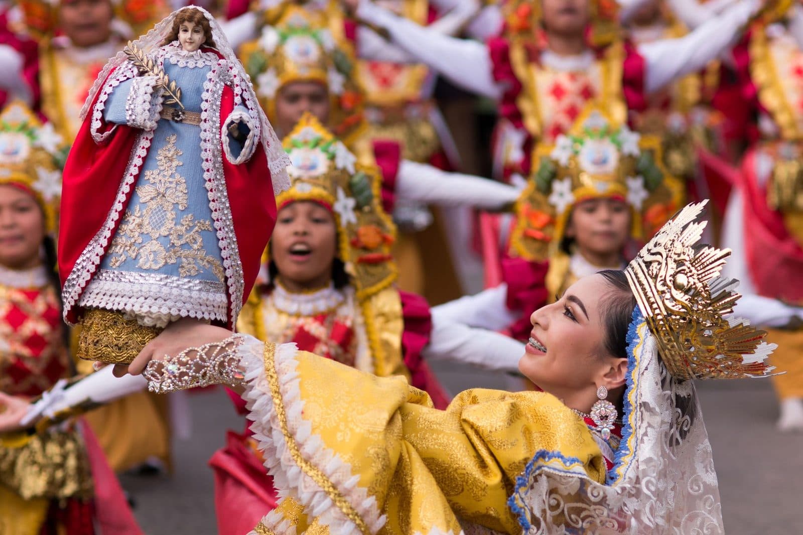 Vibrant Kuraldal Festival with traditional attire and statue of Saint Lucy.