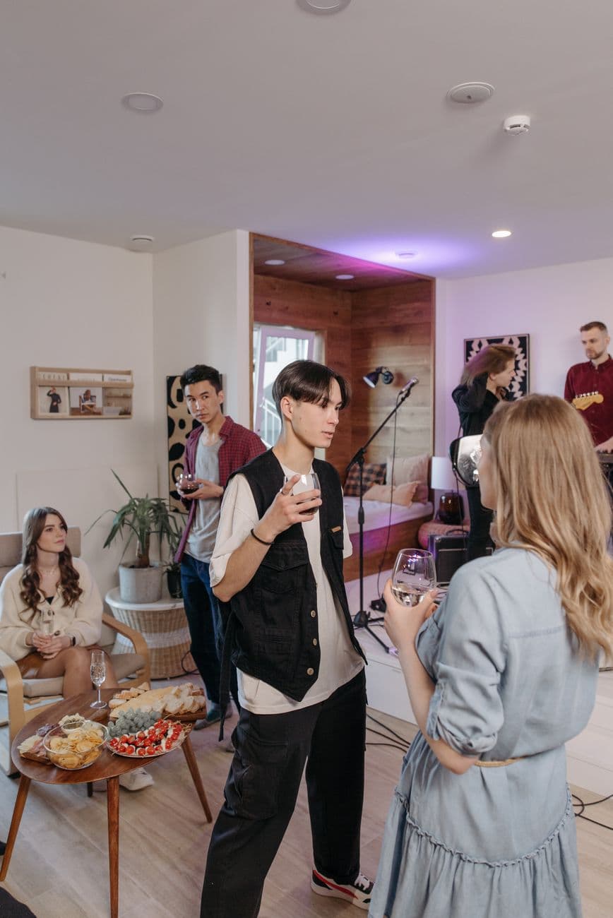 Casual indoor gathering with friends enjoying snacks and conversation.