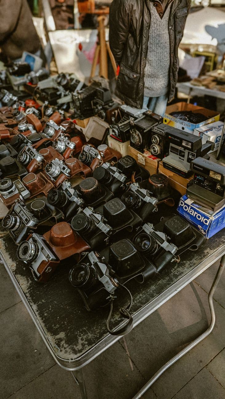 Collection of vintage cameras on sale at a Tbilisi flea market, showcasing nostalgic photography equipment.