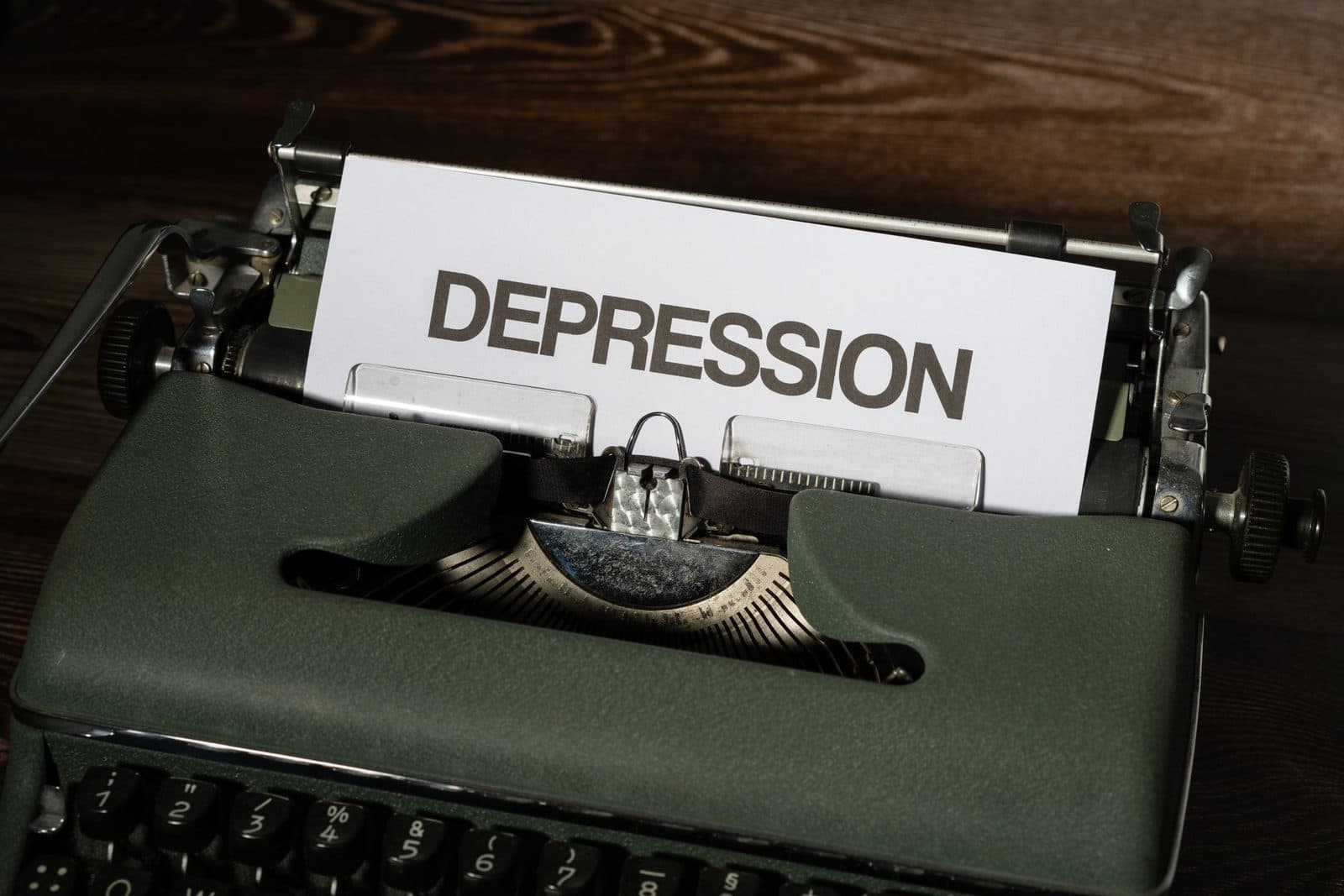 A vintage typewriter with the word 'Depression' typed on paper, conveying a mental health theme.