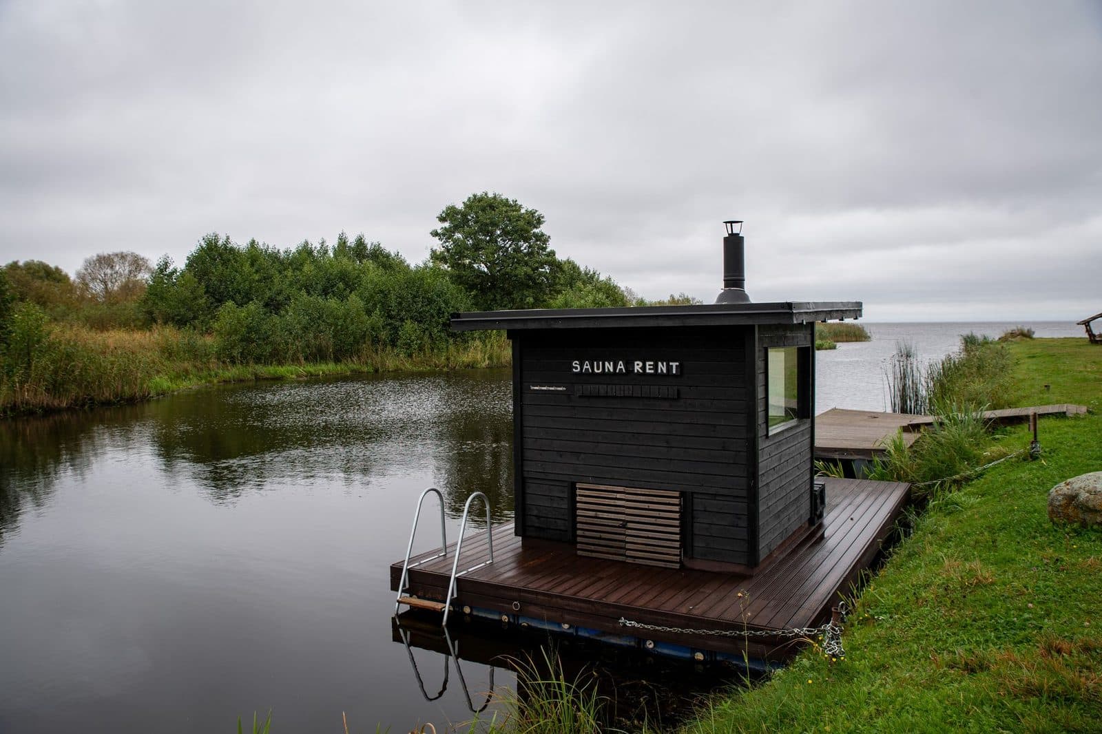A floating sauna on a peaceful lakeside in Estonia, perfect for relaxation and retreat.